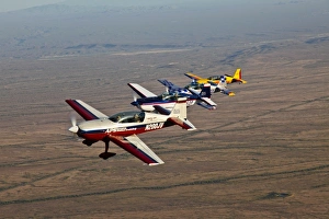 Extra 300 aerobatic aircraft fly in formation over Mesa, Arizona Extra 300 aerobatic aircraft fly in formation over Mesa, Arizona