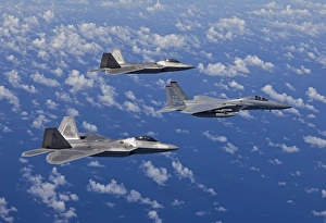 An F-15 Eagle and two F-22 Raptors fly in formation over Japan An F-15 Eagle and two F-22 Raptors fly in formation over Japan