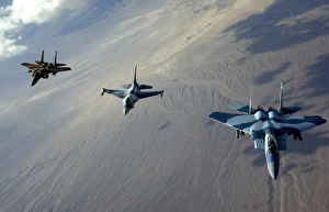 F-15 Eagles and a F-16 Fighting Falcon fly in formation F-15 Eagles and a F-16 Fighting Falcon fly in formation
