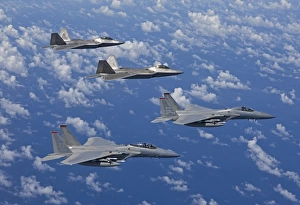 Two F-15 Eagles and F-22 Raptors fly in formation Two F-15 Eagles and F-22 Raptors fly in formation