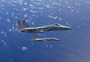 Two F-15 Eagles flies over the Pacific Ocean during a training mission Two F-15 Eagles flies over the Pacific Ocean during a training mission