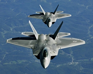 Two F-15s fly in formation behind a KC-10 Extender Two F-15s fly in formation behind a KC-10 Extender
