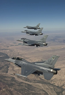 Four F-16s maneuver on a training mission over the Arizona desert Four F-16s maneuver on a training mission over the Arizona desert