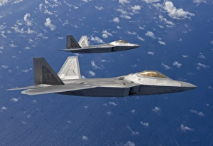 Two F-22 Raptors fly in formaton during a training mission Two F-22 Raptors fly in formaton during a training mission