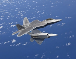 Two F-22 Raptors maneuver while flying a training mission over Japan Two F-22 Raptors maneuver while flying a training mission over Japan