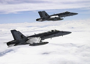 Two F/A-18C Hornets fly over the Pacific Missile Range Facility Two F/A-18C Hornets fly over the Pacific Missile Range Facility