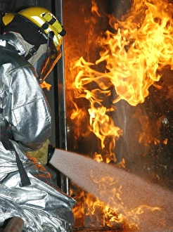 Firefighter extinguishes a simulated structural fire Firefighter extinguishes a simulated structural fire