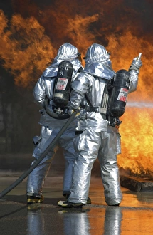 A firefighter fights a fire during a readiness training exercise A firefighter fights a fire during a readiness training exercise
