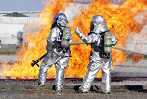 Firefighters battle a simulated fire Firefighters battle a simulated fire