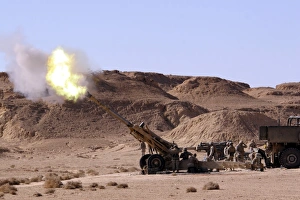 Flame and smoke emerge from the muzzle of an M198 Howitzer Flame and smoke emerge from the muzzle of an M198 Howitzer