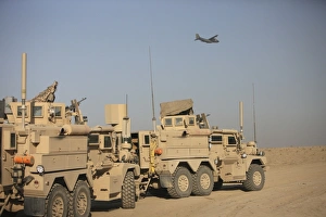 A German Transall C-160 flies over two EOD Cougar armored vehicles A German Transall C-160 flies over two EOD Cougar armored vehicles