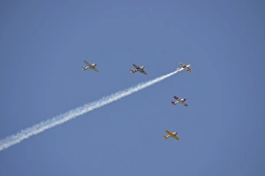A group of restored vintage warbirds fly in formation A group of restored vintage warbirds fly in formation
