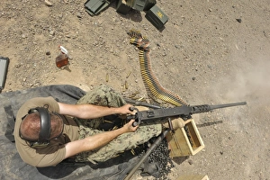 Gunners Mate fires an M2 .50-caliber machine gun Gunners Mate fires an M2 .50-caliber machine gun