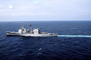 An HH-60H Sea Hawk helicopter perpares to land aboard the guided-missile cruiser An HH-60H Sea Hawk helicopter perpares to land aboard the guided-missile cruiser