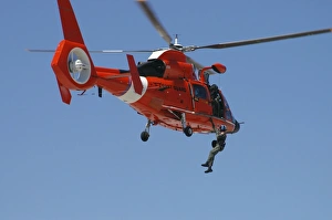 An HH-65C Dolphin demonstrates a helicopter rescue An HH-65C Dolphin demonstrates a helicopter rescue
