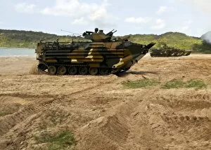 Aav 7a1 Collection: Korean amphibious assault vehicles moving across the beach during a simulated amphibious