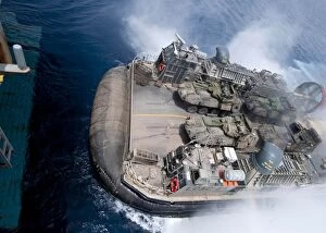Air Cushioned Landing Craft Collection: A landing craft air cushion enters teh well deck of USS Iwo Jima