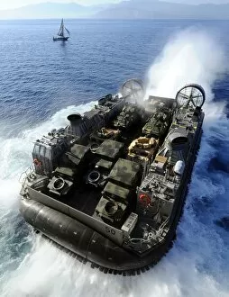 Air Cushioned Landing Craft Collection: A Landing Craft Air Cushion exits the well deck of USS Bataan