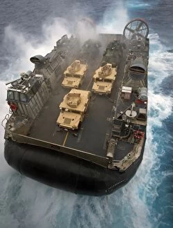 Air Cushioned Landing Craft Collection: A Landing Craft Air Cushion exits the well deck of USS Bonhomme Richard