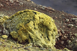 Lava bomb coated in yellow sulphurous fumarole deposits Lava bomb coated in yellow sulphurous fumarole deposits