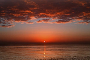 A layer of clouds is lit by the rising sun over Rio de la Plata, Buenos Aires, Argentina A layer of clouds is lit by the rising sun over Rio de la Plata, Buenos Aires, Argentina