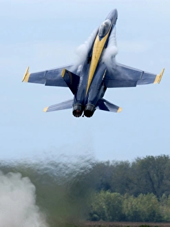 Lead solo pilot of the Blue Angels performs a high performance climb Lead solo pilot of the Blue Angels performs a high performance climb