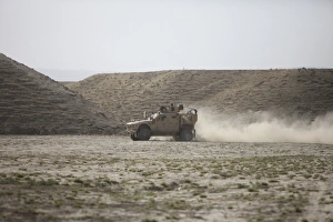 An M-ATV races across the wadi near Kunduz, Afghanistan An M-ATV races across the wadi near Kunduz, Afghanistan