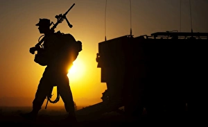 A machine gunner prepares to load an amphibious assault vehicle A machine gunner prepares to load an amphibious assault vehicle