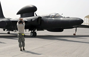 A maintenance Airman guides a pilot in a U-2 Dragon Lady aircraft to a parking space A maintenance Airman guides a pilot in a U-2 Dragon Lady aircraft to a parking space