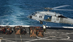 Marines attach cargo to an MH-60S Sea Hawk helicopter Marines attach cargo to an MH-60S Sea Hawk helicopter