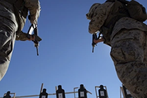 Marines change magazines in the midst of firing Marines change magazines in the midst of firing