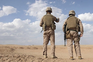 Marines scan the horizon for insurgent activity during a security patrol Marines scan the horizon for insurgent activity during a security patrol