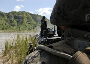 Members of the Philippine Armed Forces fire the weapons systems of a light armored Members of the Philippine Armed Forces fire the weapons systems of a light armored