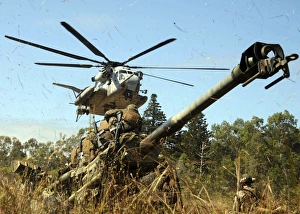 An MH-53E Sea Stallion helicopter preparing to lift an M777 105-mm lightweight Howitzer An MH-53E Sea Stallion helicopter preparing to lift an M777 105-mm lightweight Howitzer