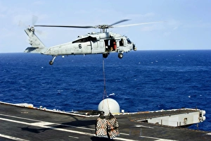 An MH-60R Seahawk helicopter places cargo onto the flight deck of USS Nimitz An MH-60R Seahawk helicopter places cargo onto the flight deck of USS Nimitz