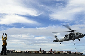 An MH-60S Sea Hawk lifts a pallet of ordnance from the aircraft carrier USS Ronald Reagan An MH-60S Sea Hawk lifts a pallet of ordnance from the aircraft carrier USS Ronald Reagan