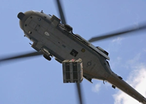 An MH-60S Seahawk helicopter airlifts a pallet of ammunition An MH-60S Seahawk helicopter airlifts a pallet of ammunition