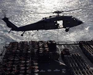 An MH-60S Seahawk helicopter conducts a vertical replenishment An MH-60S Seahawk helicopter conducts a vertical replenishment