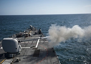 An Mk-45 lightweight gun is fired aboard guided missile destroyer USS Arleigh Burke An Mk-45 lightweight gun is fired aboard guided missile destroyer USS Arleigh Burke