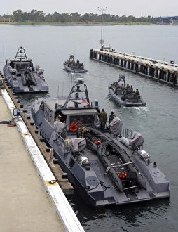 A MK-V Special Operations Craft tied pierside manned and loaded with combat rubber A MK-V Special Operations Craft tied pierside manned and loaded with combat rubber