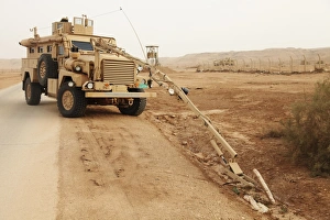 Middle East Military Operations Prints: A MRAP vehicle disassembles an improvised explosive device