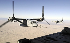 A MV-22 Osprey refuels midflight while another waits its turn A MV-22 Osprey refuels midflight while another waits its turn