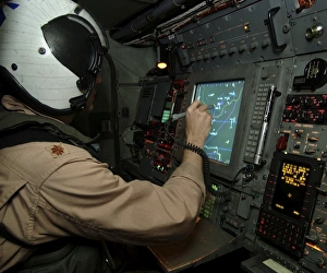 A Naval Flight Officer tracks aircraft at his station on an E-2C Hawkeye A Naval Flight Officer tracks aircraft at his station on an E-2C Hawkeye