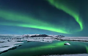 The northern lights dance over the glacier lagoon in Iceland The northern lights dance over the glacier lagoon in Iceland