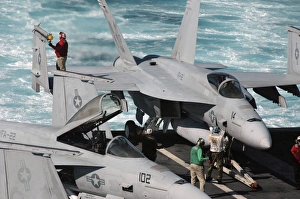 Ordnancemen perform checks on a F/A-18E Super Hornet aircraft Ordnancemen perform checks on a F/A-18E Super Hornet aircraft
