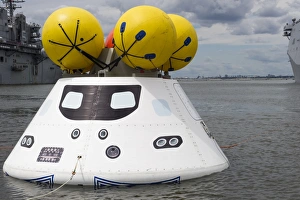 An Orion capsule before being towed into the well deck of USS Arlington An Orion capsule before being towed into the well deck of USS Arlington