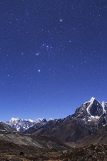 The Orion constellation above the moonlit landscape of the Himalayas in Nepal The Orion constellation above the moonlit landscape of the Himalayas in Nepal