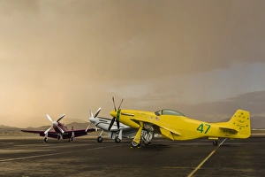 Three P-51 Mustangs parked on the ramp ahead of a storm Three P-51 Mustangs parked on the ramp ahead of a storm