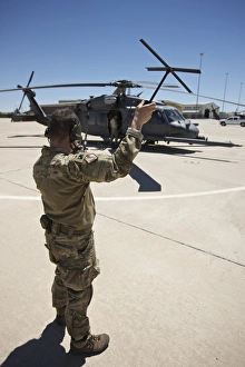 Pararescuemen conducts a communications check with his Sat radio Pararescuemen conducts a communications check with his Sat radio