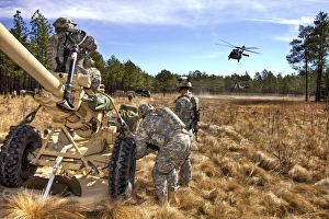 Paratroopers prepare to hook up an M119A2 howitzer to a UH-60M Black Hawk Paratroopers prepare to hook up an M119A2 howitzer to a UH-60M Black Hawk